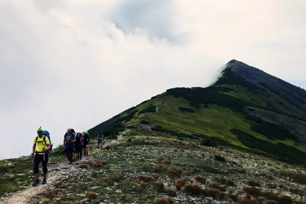 group descending steep peak